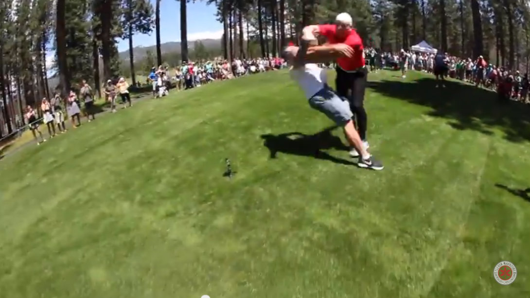 A.J. Hawk lays the wood on a fan at golf tournament