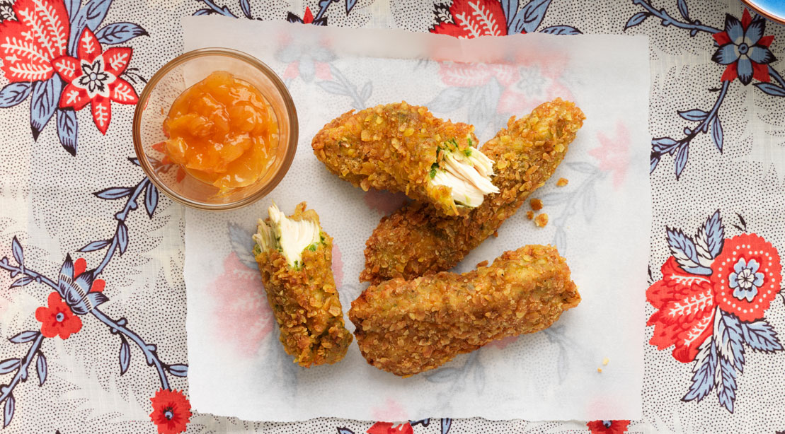 Breaded chicken strips on floral table cloth