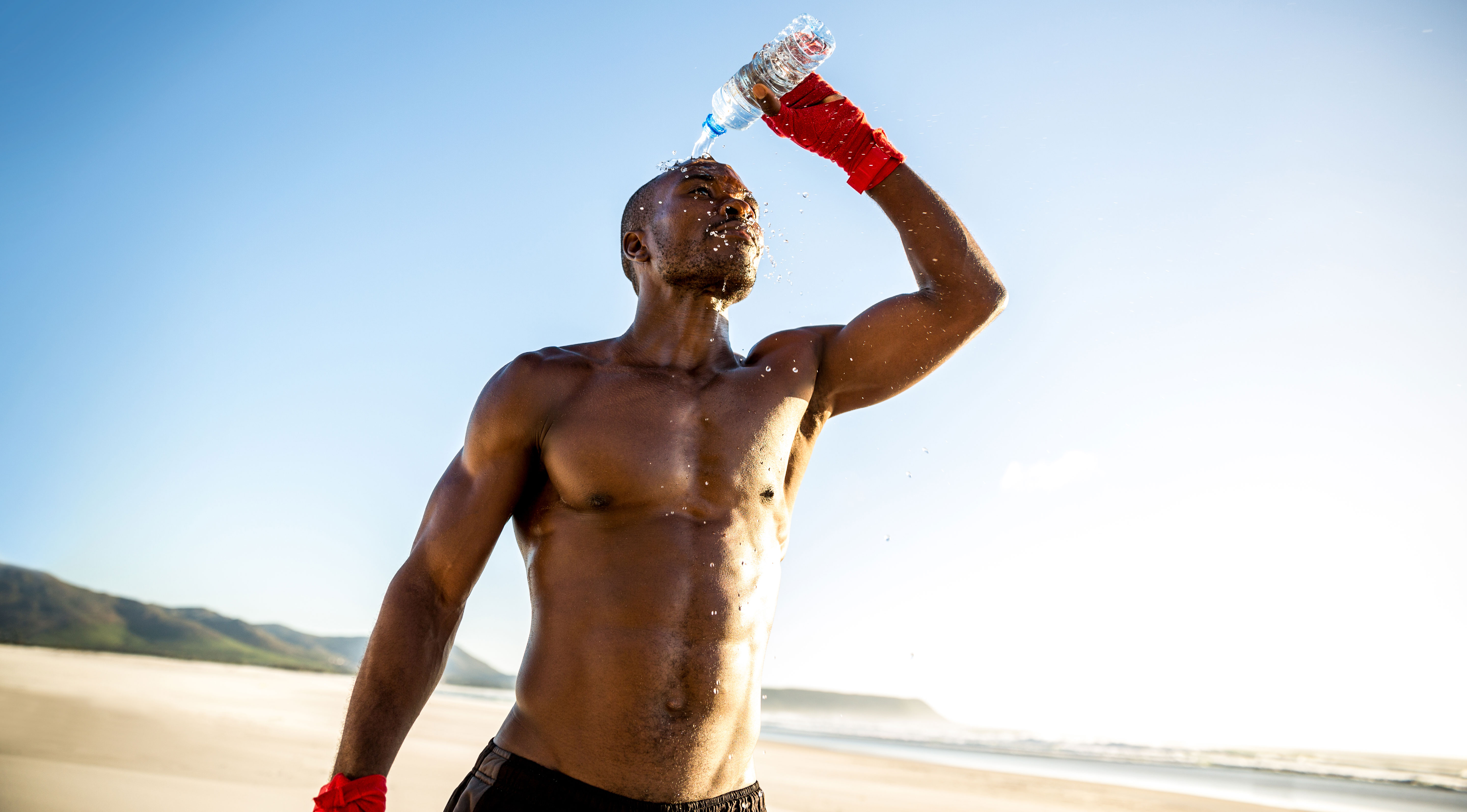 Man At Beach Showing Abs