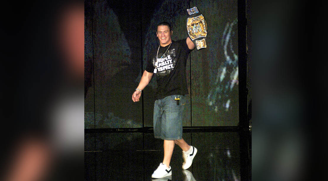 WWE wrestler John Cena holding the WWE wrestling championship belt