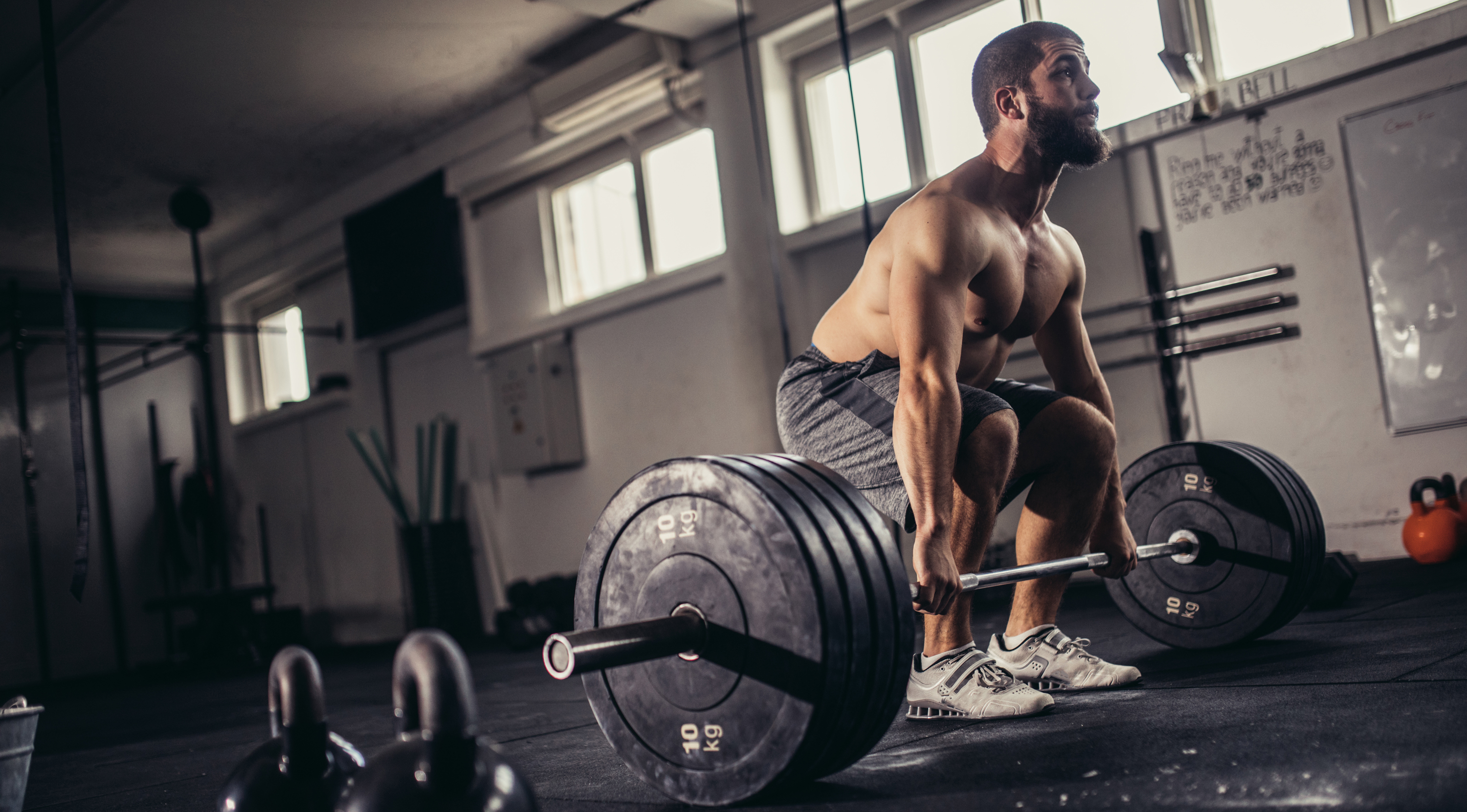 Man Deadlifting in Gym