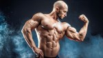 Bald muscular bodybuilder with big biceps muscle after following accessory training methods