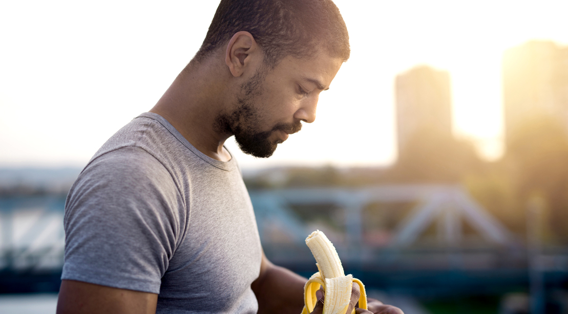 Man eating a banana in the city