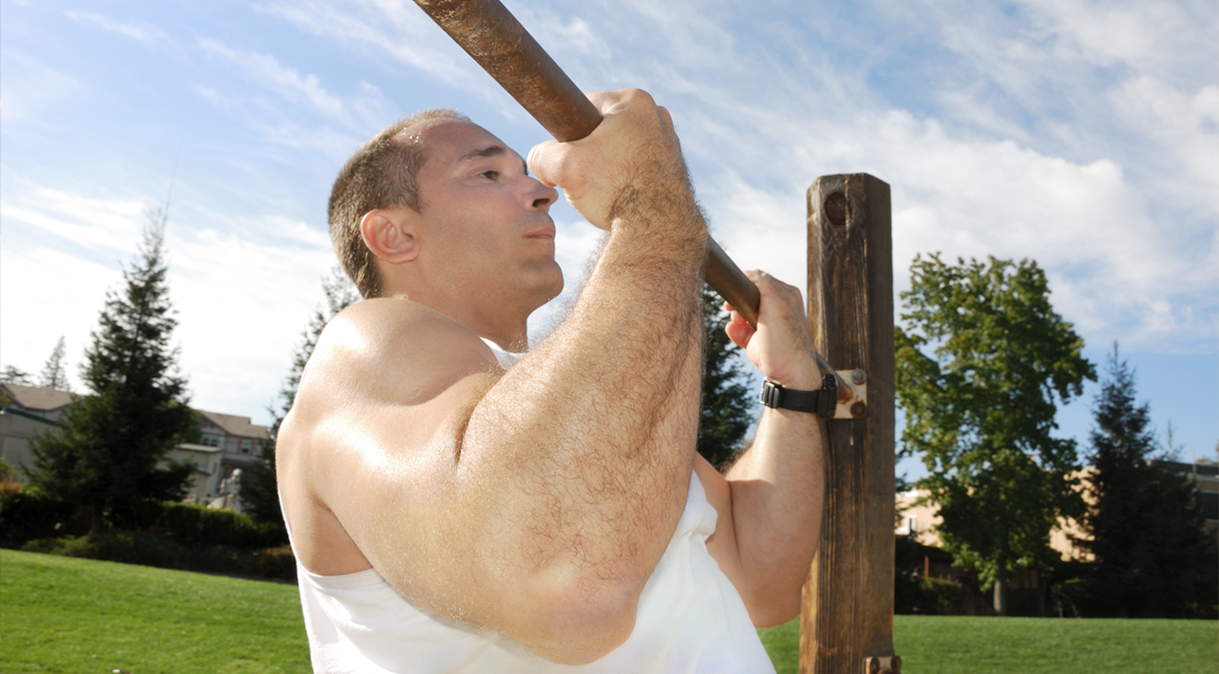 Man Doing Underhanded Pullup Outdoors