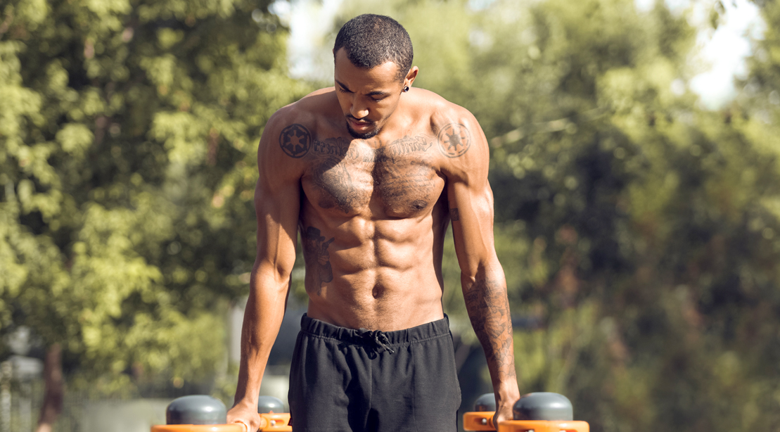 Muscular-Black-Man-Performing-Outdoor-Dip-While-Shirtless