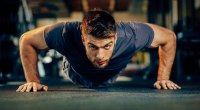 bearded man doing chest workout with a pushup exercise