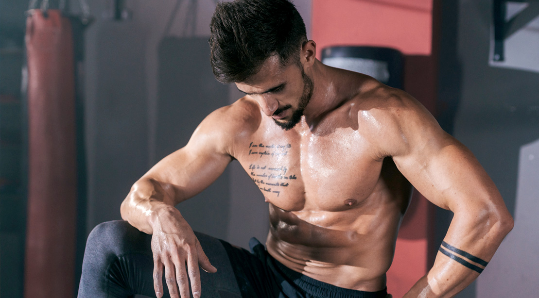 Sweaty muscular man resting after a HIIT workout