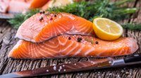 Healthy raw salmon filet with a lemon that helps lower your blood sugar levels