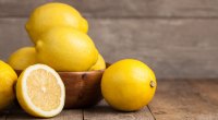 Healthy whole lemons stacked in a bowl and used to lower blood sugar levels