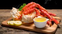 Alaskan king crab legs on a wooden serving board containing the micronutrient zinc