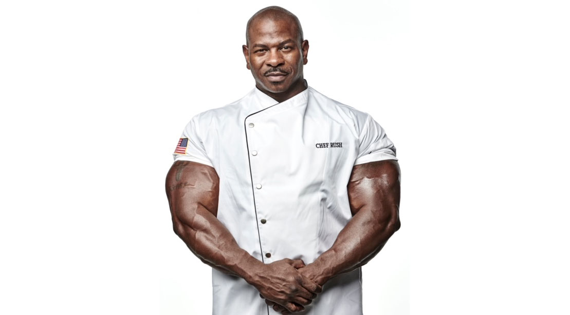 https://www.muscleandfitness.com/wp-content/uploads/2021/08/Chef-Andre-Rush-showing-off-his-massive-arms-while-wearing-a-chef-jacket.jpg?quality=86&strip=all