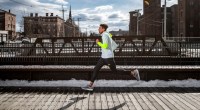 Middle-Distance runner Isaiah Harris running on a runner path in the city