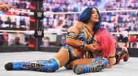 Female wrestler Sasha Banks with her opponent in a headlock