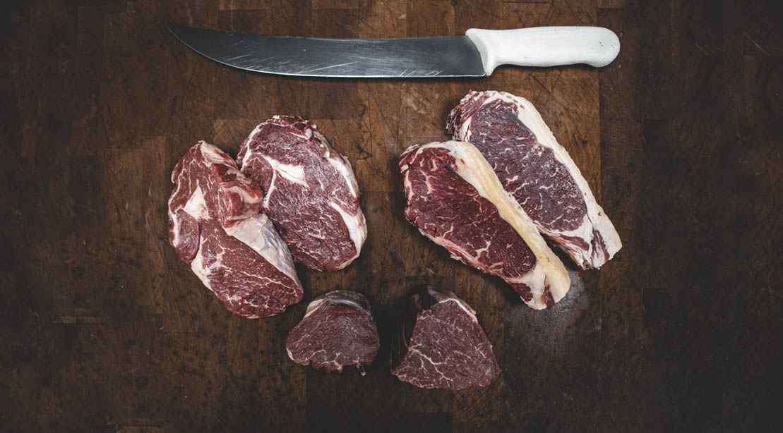 Different cuts of meat on a butcher block