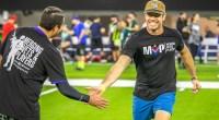 Nate Boyer running on the football field giving low fives