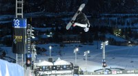 Scotty James performing a snowboard trick off the half pipe