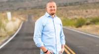 Swimmer Ben Beard standing in the middle of a road